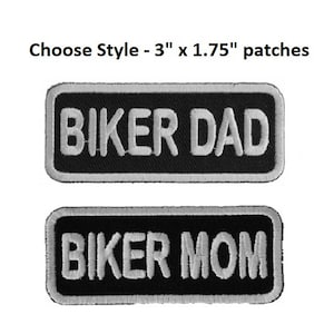 May include: Two rectangular patches with the text "BIKER DAD" and "BIKER MOM" in white, embroidered on a black background. Each patch is outlined in white. The text "Choose Style - 3" x 1.75" patches" is above the patches.