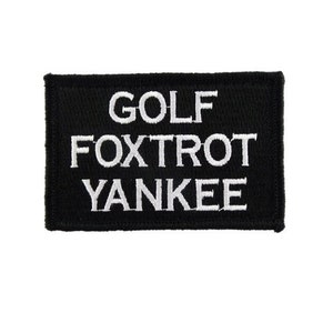 May include: Black embroidered patch with white text that reads "GOLF FOXTRT YANKEE".
