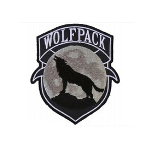May include: Black and white embroidered patch with a wolf howling at the moon. The patch has the text "Wolfpack" in white lettering.