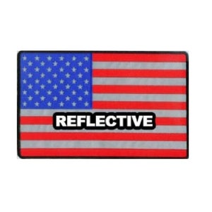 May include: A red, white, and blue American flag patch with the word "REFLECTIVE" printed in white on the center stripe.