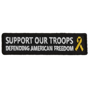 May include: Black embroidered patch with white text that reads "Support Our Troops Defending American Freedom" and a yellow ribbon.