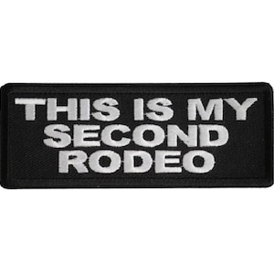May include: Black rectangular patch with the text "THIS IS MY SECOND RODEO" in white block letters. The patch has a black border and is likely made of fabric, suitable for sewing or ironing onto clothing or accessories.
