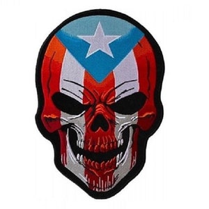 May include: A red, white, and blue skull patch with the Puerto Rican flag design. The skull is outlined in black and has a white star on the forehead.
