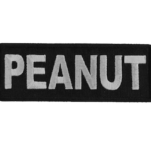 May include: Black fabric patch with the word "PEANUT" embroidered in white.