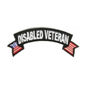 May include: Black and white embroidered patch with the text "DISABLED VETERAN" in a curved banner with American flags on each end.