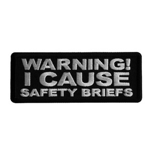 May include: Black and white embroidered patch with the text "WARNING! I CAUSE SAFETY BRIEFS".