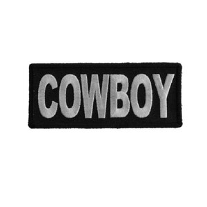May include: Black embroidered patch with the word "COWBOY" in white lettering.