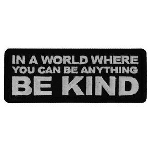 May include: Black and white embroidered patch with the text "In a world where you can be anything be kind."