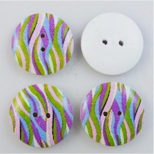 May include: Set of four wooden buttons with a colorful zebra stripe pattern. Two buttons are white with two holes, and two buttons have a green, pink, purple, and blue zebra stripe pattern.
