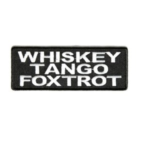 May include: Black embroidered patch with white text that reads "Whiskey Tango Foxtrot".