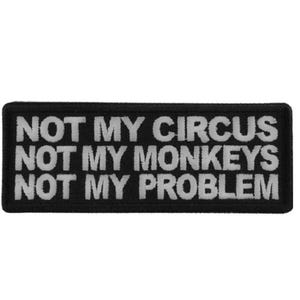 May include: Black rectangular patch with white embroidered text that reads "NOT MY CIRCUS NOT MY MONKEYS NOT MY PROBLEM". The patch is a simple, bold statement.