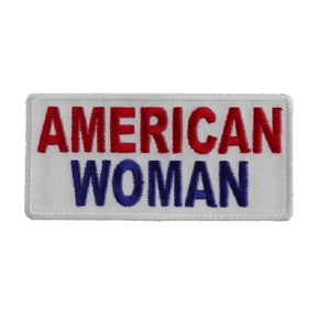 May include: White embroidered patch with the text "AMERICAN WOMAN" in red and blue thread.