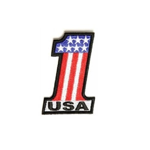 May include: Embroidered patch with a red, white, and blue American flag design in the shape of the number one. The patch has the word "USA" written in black below the flag.