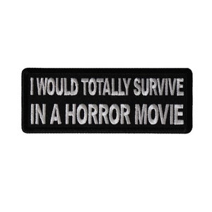 May include: Black and white embroidered patch with the text "I would totally survive in a horror movie".
