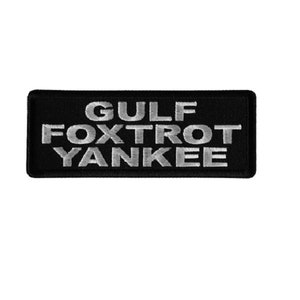 May include: Black embroidered patch with white text that reads "GULF FOXTROT YANKEE".