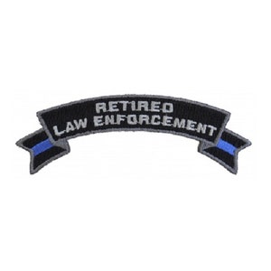 May include: Black and gray embroidered patch with a blue line. The patch is shaped like a banner and reads "Retired Law Enforcement".