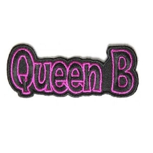 May include: Black fabric patch with pink outline that reads "Queen B".