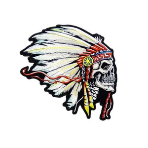 May include: A black and white skull wearing a red, white, and blue headdress with feathers. The headdress has a yellow starburst design.