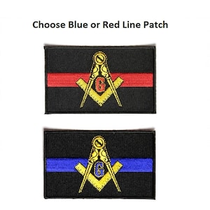May include: Two black embroidered patches with a gold compass and square design. The top patch has a red stripe across the middle and the bottom patch has a blue stripe across the middle. Choose blue or red line patch.