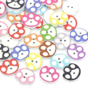 May include: Assortment of colorful wooden buttons with a paw print design. The buttons are various colors, including red, orange, yellow, green, blue, purple, and black.