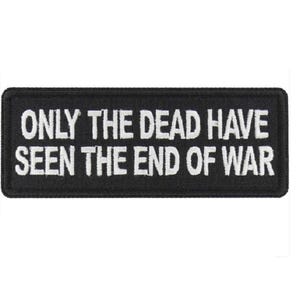 May include: Black embroidered patch with white text that reads "Only the dead have seen the end of war."