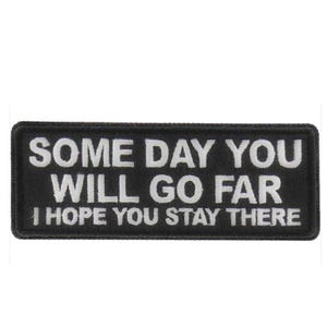May include: Black rectangular patch with white text that reads "SOME DAY YOU WILL GO FAR I HOPE YOU STAY THERE". The patch has a stitched border and is likely an iron-on or sew-on.