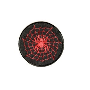 May include: A black embroidered patch with a red spider and web design.
