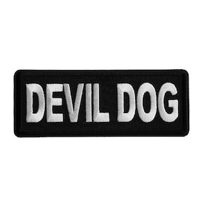 May include: Black embroidered patch with white text that reads "DEVIL DOG".