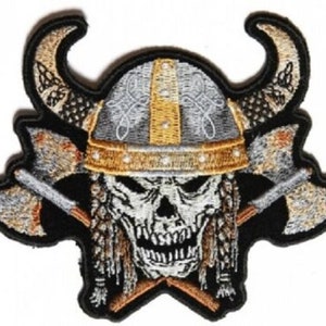 May include: Embroidered patch featuring a skull wearing a horned Viking helmet with crossed axes behind it. The skull is white with black eyes and a gold trim on the helmet.