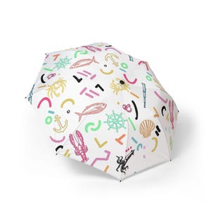 Colorful coastal semi-automatic foldable umbrella.  Nautical theme