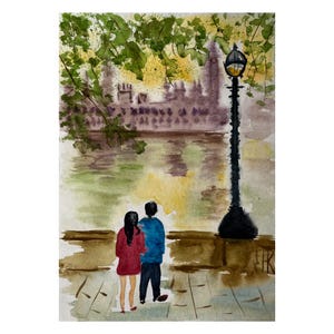 May include: A watercolor painting depicting two figures standing on a paved embankment, one in a red top and one in a blue top, facing a river. A tall black lamppost stands to the right, with green tree branches above and a building silhouette.