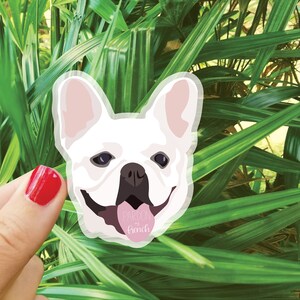 May include: A white French bulldog with a pink tongue sticking out, smiling with the text "Pardon my French" on a pink heart.