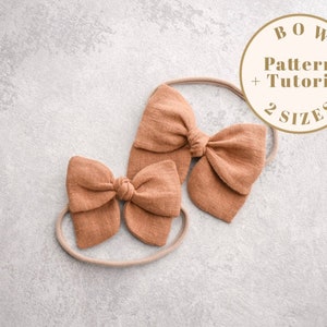 May include: Two brown fabric bows on nude headbands. The bows are tied in a knot and have a slightly textured fabric. The text "BOW Pattern + Tutorial 2 SIZES" is in a circle on a white background.
