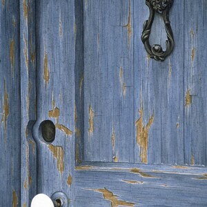 May include: A close-up of a weathered blue wooden door with a white porcelain door knob and a decorative metal door knocker. The door is painted a light blue color and has a distressed look with chipped paint.