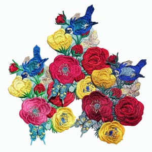 May include: Embroidered iron-on patch featuring a floral design with red, yellow, and pink flowers, blue birds, and butterflies.