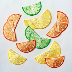 May include: Assortment of colorful iron-on patches featuring various citrus fruits, including lemons, limes, and oranges. The patches are perfect for adding a touch of whimsy to clothing, bags, or other fabric items.