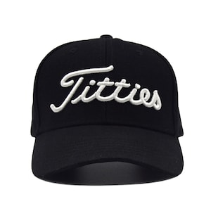 May include: Black baseball cap with a white embroidered logo that says "Titties".