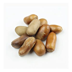 May include: A close-up of a pile of brown and tan dried fruit seeds. The seeds are oval-shaped and have a slightly wrinkled texture.