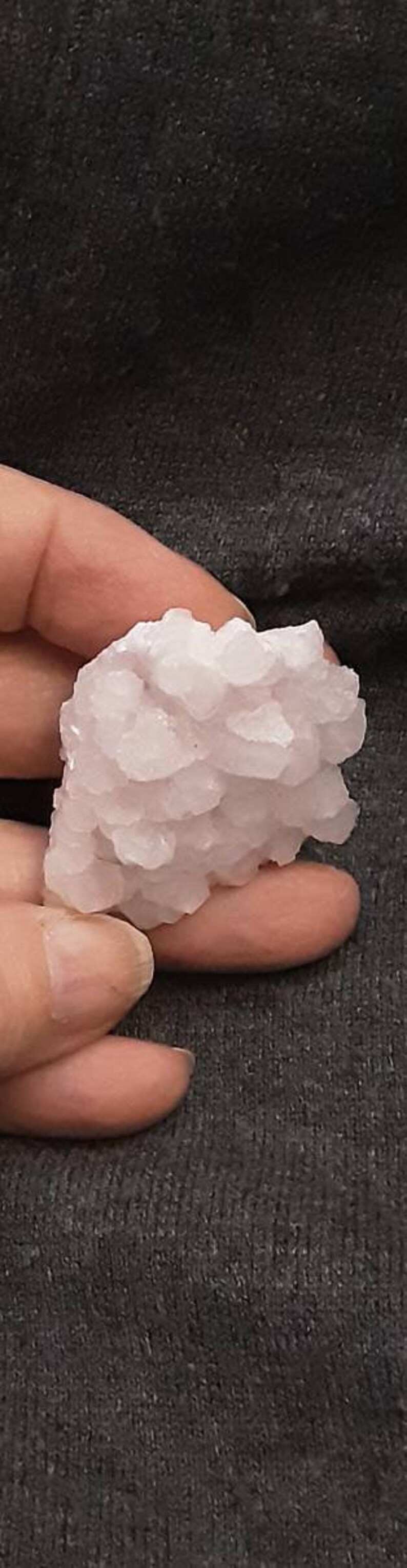 May include: A cluster of pink selenite crystals, a type of gypsum, with a rough, textured surface.