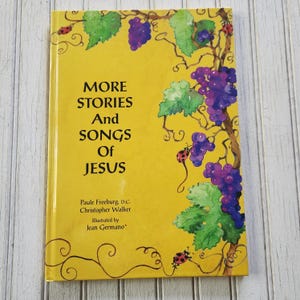 May include: A yellow book cover with a vine of grapes and ladybugs. The title is "More Stories And Songs Of Jesus". The authors are Paule Freeburg, D.C. and Christopher Walker. The illustrator is Jean Germano.