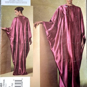 May include: A dressmaking pattern for a long, flowing gown in a deep rose hue. The pattern is labelled "V1181" and features the designer's name, "CHADO ralph rucci". The size is indicated as "Lrg-Xlg". The image shows a model wearing the finished garment.