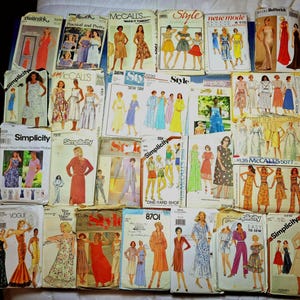 May include: A collection of vintage sewing patterns from brands like Simplicity, McCall's, and Vogue. The patterns feature illustrations of dresses, skirts, and other garments. The patterns are in various sizes and styles, with colorful cover art.