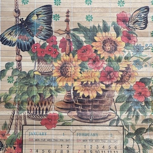 May include: A decorative calendar with a floral design, including sunflowers, red roses, and butterflies. The calendar shows January and February. The background has a light brown, wood-effect texture.