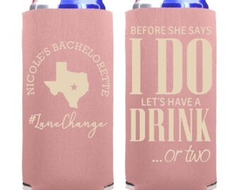 May include: Two pink can coolers with white text. The left cooler has a Texas outline with a star and the text "Nicole's Bachelorette #LaneChange". The right cooler has the text "Before she says I do let's have a drink...or two".