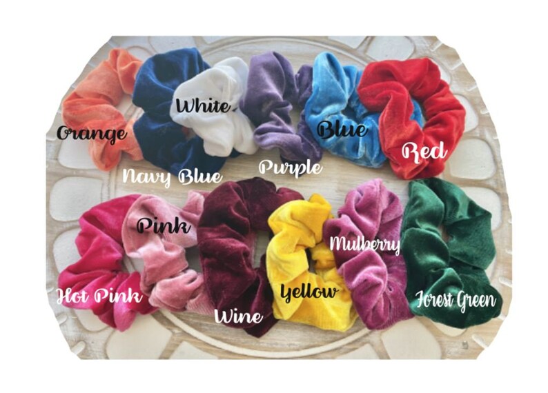 May include: Assortment of 12 velvet scrunchies in various colors, including orange, white, navy blue, purple, blue, red, pink, hot pink, wine, mulberry, yellow, and forest green.
