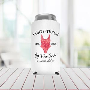 May include: White can cooler with the text "Forty-Three Mar. 2025 by the Sea Islamorada, FL" and a red and white polka dot swimsuit graphic.