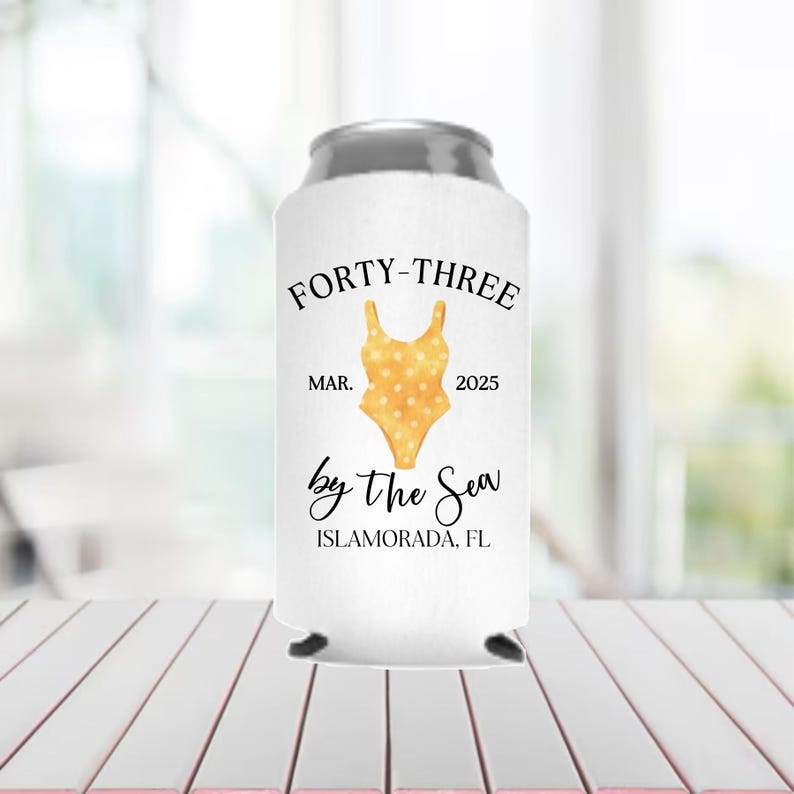 May include: White can cooler with a yellow polka dot swimsuit design and the text "Forty-Three Mar. 2025 by the Sea Islamorada, FL"