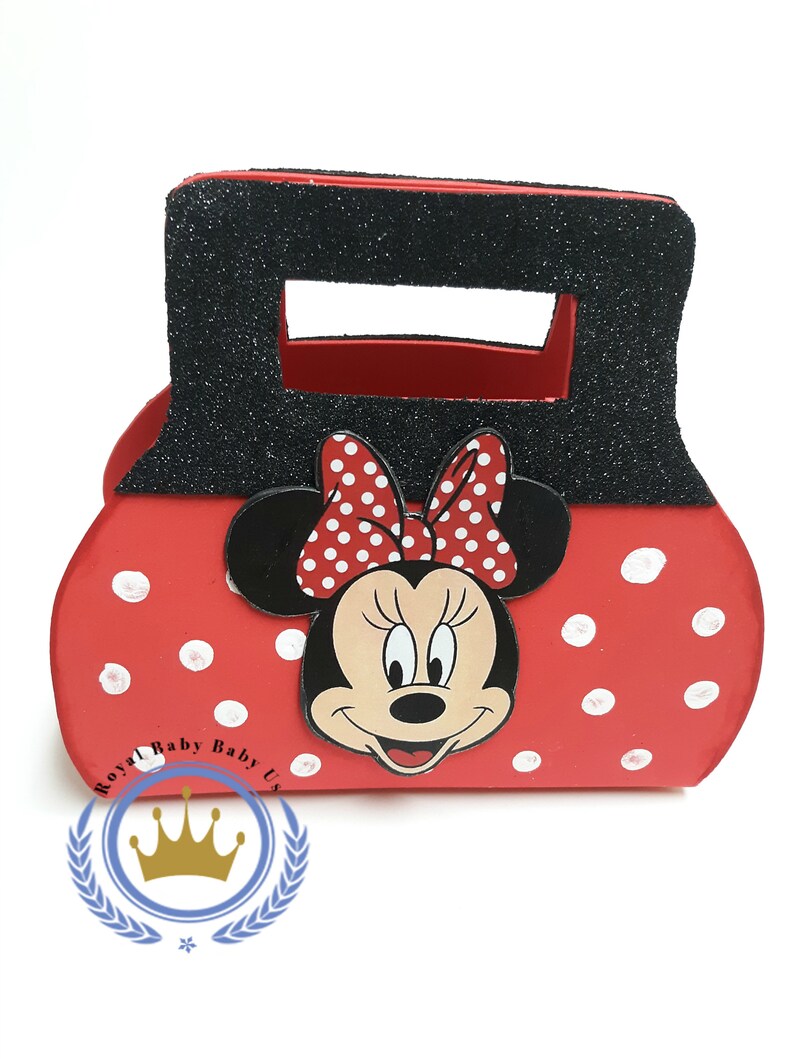 May include: Red and black Minnie Mouse-themed purse with white polka dots. The purse features a black handle with glitter and a Minnie Mouse face with a red and white polka dot bow. The purse has the text "Royal Baby Baby Us".