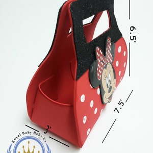 May include: Red Minnie Mouse-themed gift bag with white polka dots and a black glitter handle. The bag is 7.5 inches long, 6.5 inches high, and 3 inches wide. Features a Minnie Mouse face and bow.