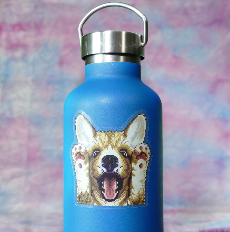 May include: A blue reusable water bottle with a sticker of a smiling corgi dog with its paws up.